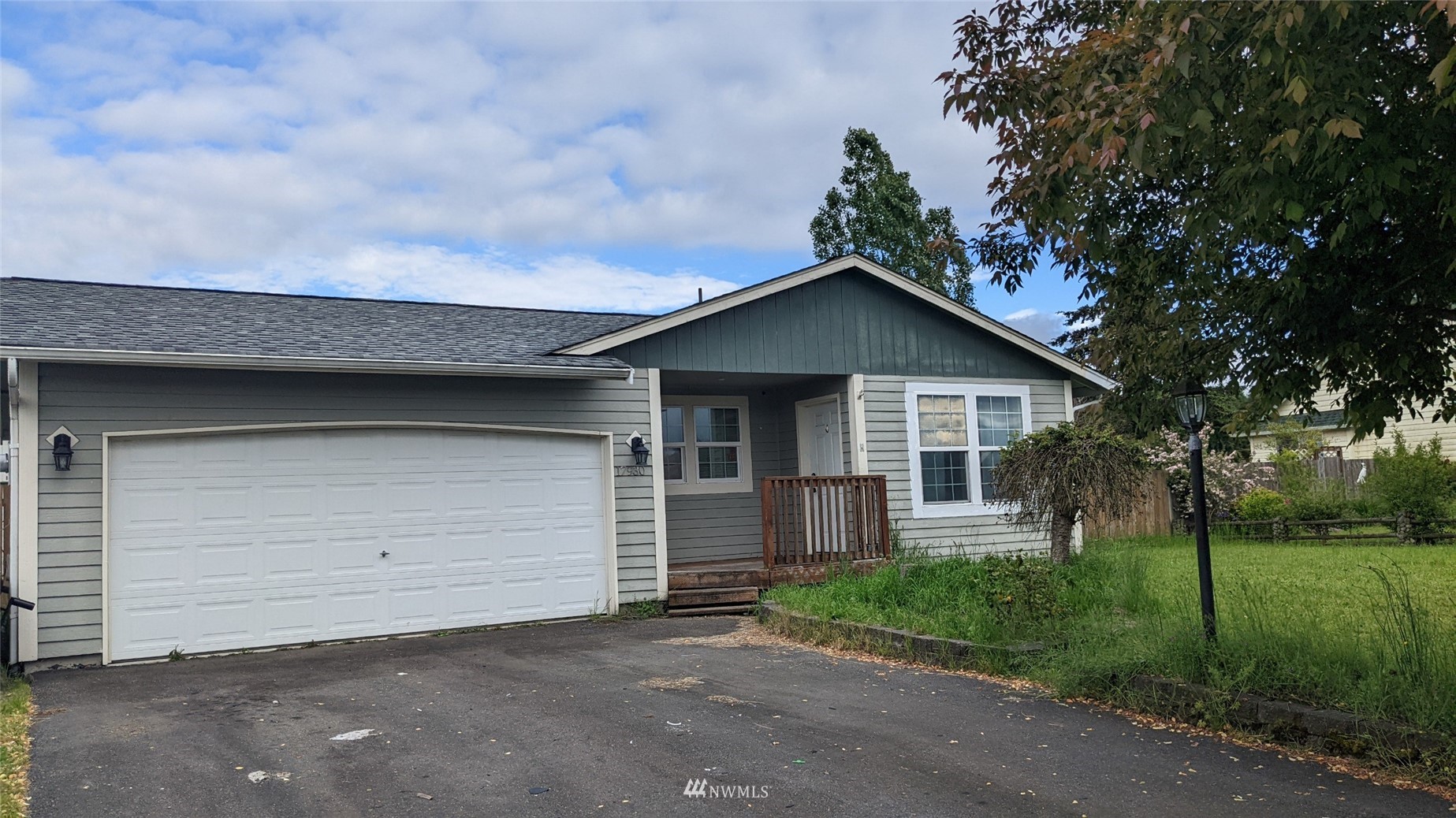 a front view of a house with garage