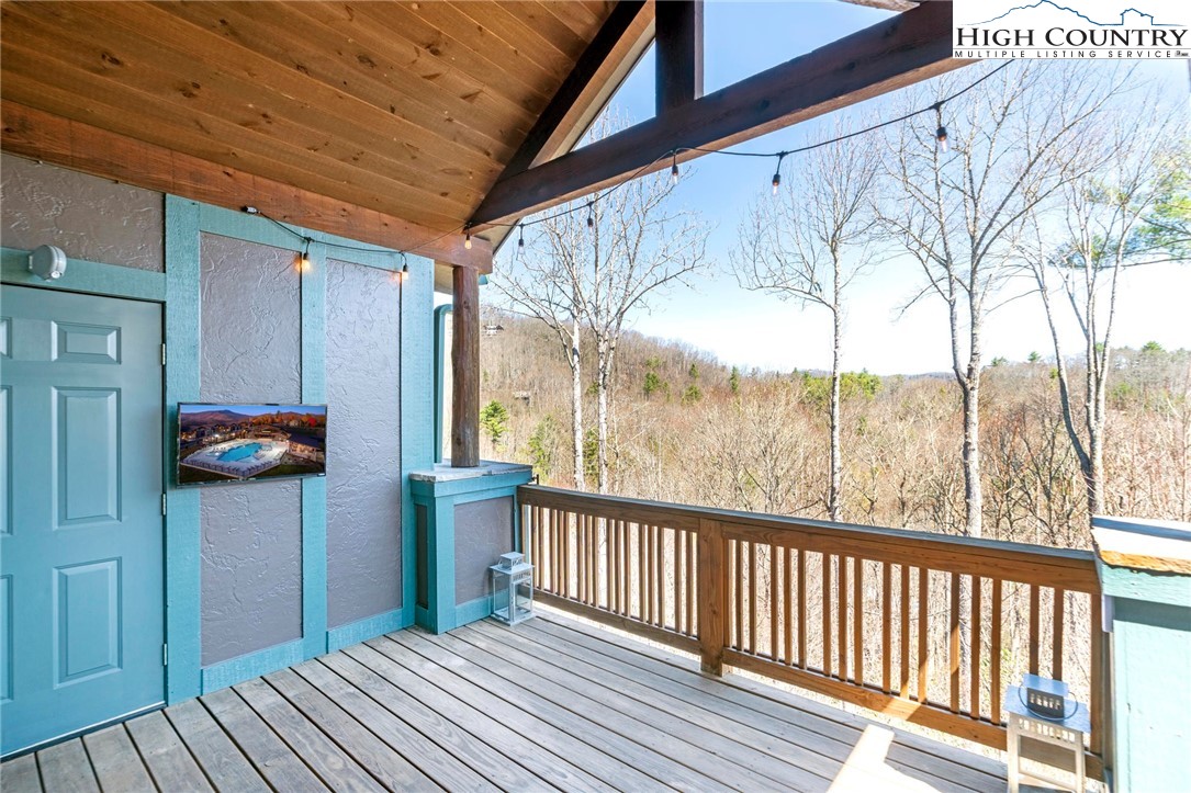 446 Peaceful Haven Drive, Unit 832 Boone, NC 28607 - Photo 16 of 38 a view of a porch with wooden floor and fence