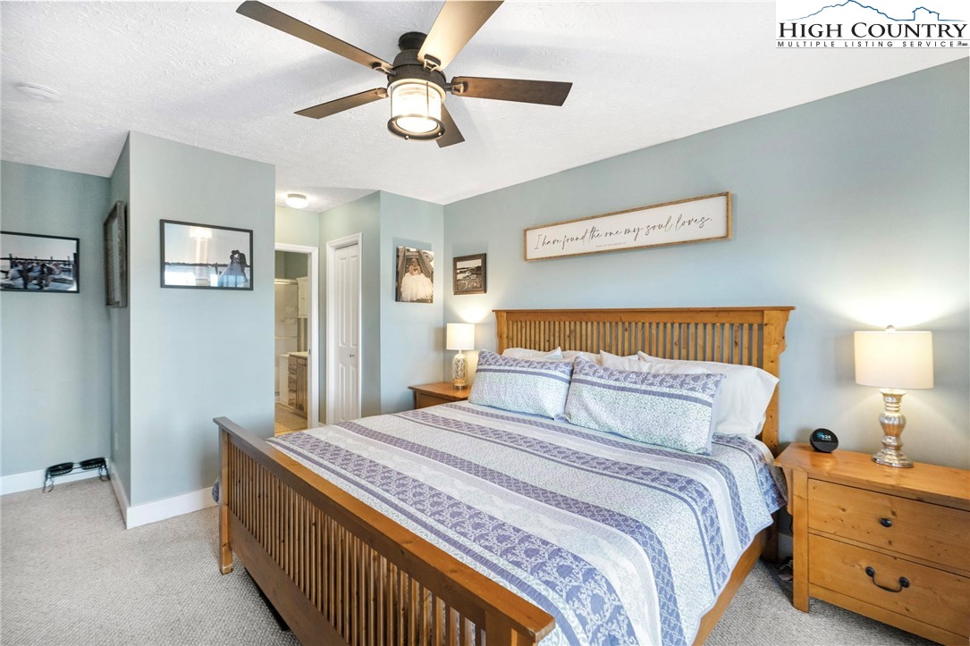 446 Peaceful Haven Drive, Unit 832 Boone, NC 28607 - Photo 18 of 38 a bedroom with a bed and a chandelier