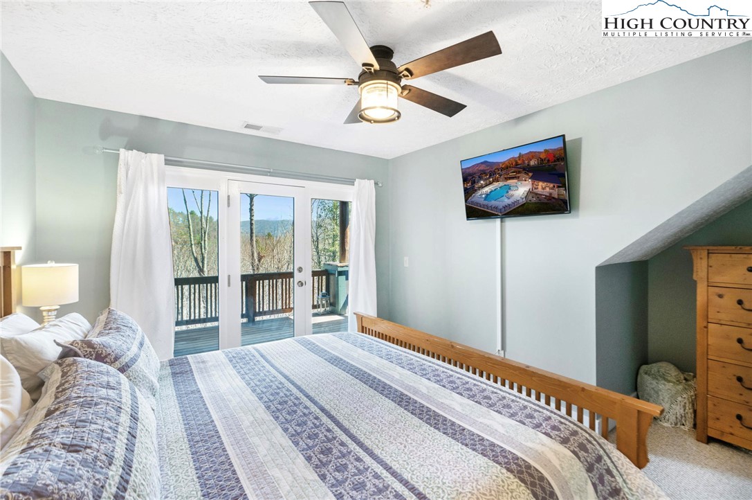 446 Peaceful Haven Drive, Unit 832 Boone, NC 28607 - Photo 20 of 38 a bedroom with a bed and a flat screen tv