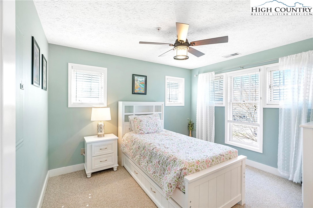 446 Peaceful Haven Drive, Unit 832 Boone, NC 28607 - Photo 22 of 38 a bedroom with a bed and a window