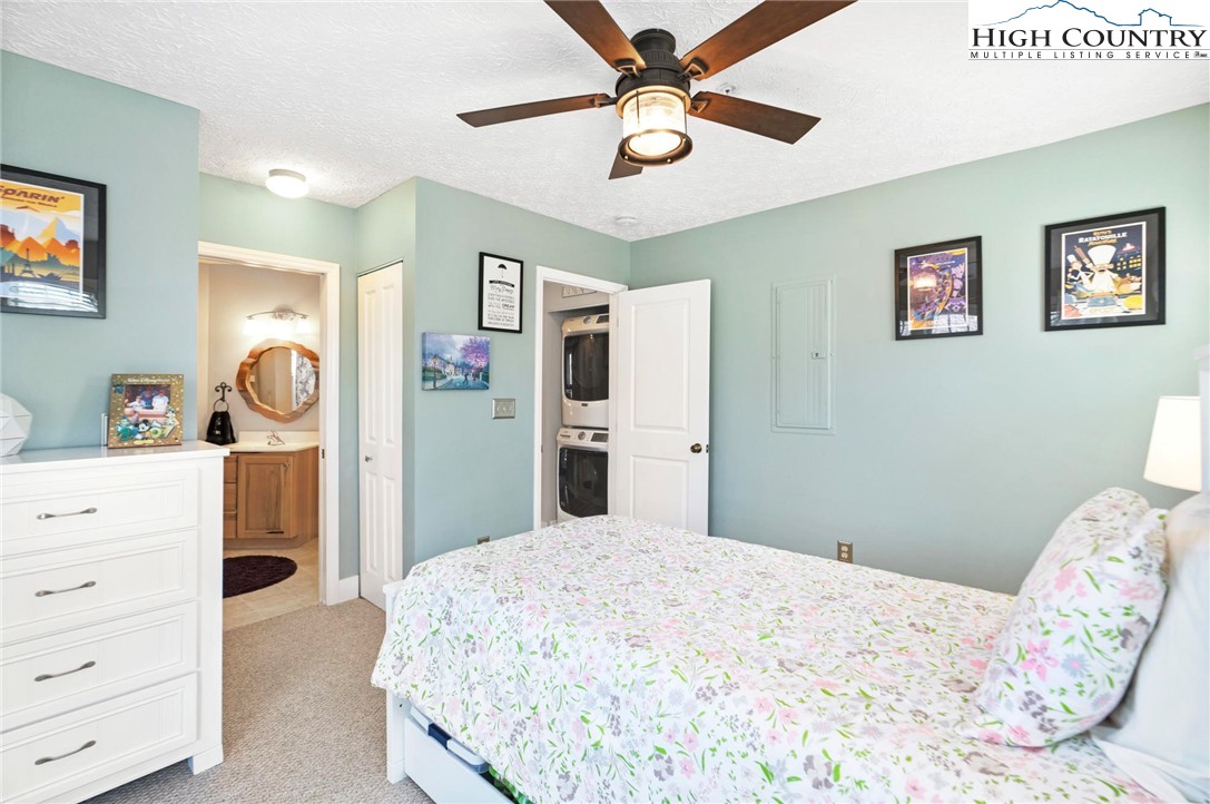 446 Peaceful Haven Drive, Unit 832 Boone, NC 28607 - Photo 24 of 38 a bedroom with a bed and a chandelier