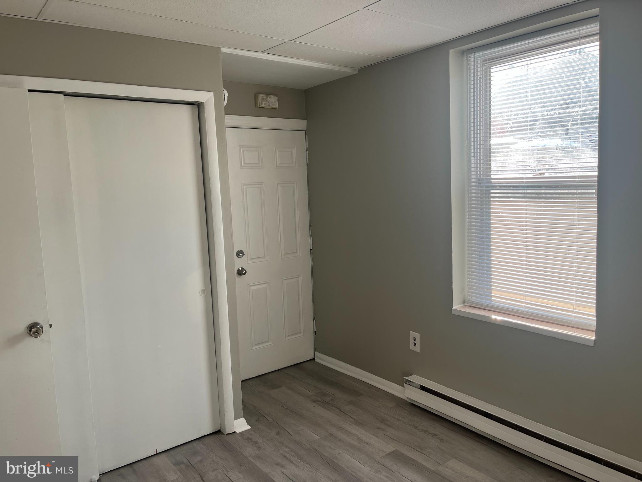 2666-00 Bridge Street Philadelphia, PA 19137 - Photo 4 of 13 a view of an empty room with wooden floor and a window