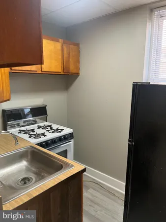 a stove top oven sitting inside of a kitchen