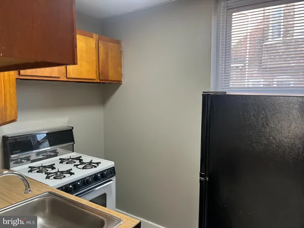 a stove top oven sitting inside of a kitchen