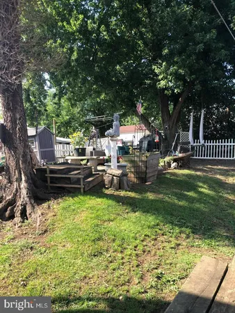a backyard of a house with yard and outdoor seating