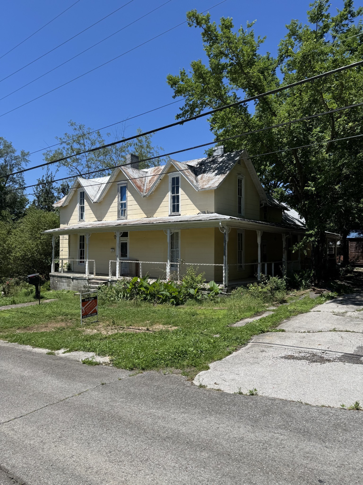 a front view of a house with a garden and pathway