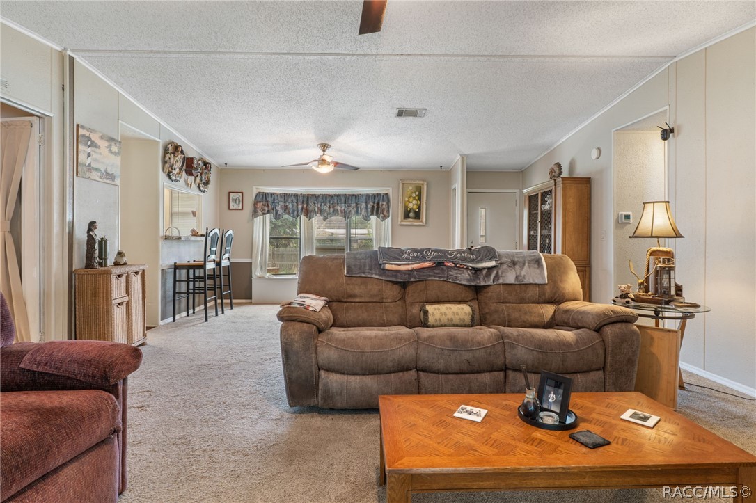 7927 West Cyprian Court Homosassa, FL 34448 - Photo 8 of 40 a living room with furniture and a large window