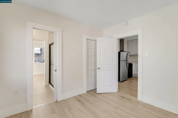 an empty room with closet and wooden floor