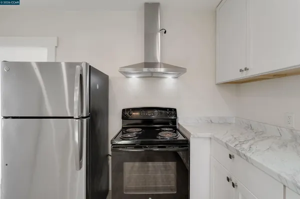 a kitchen with a stove and a refrigerator