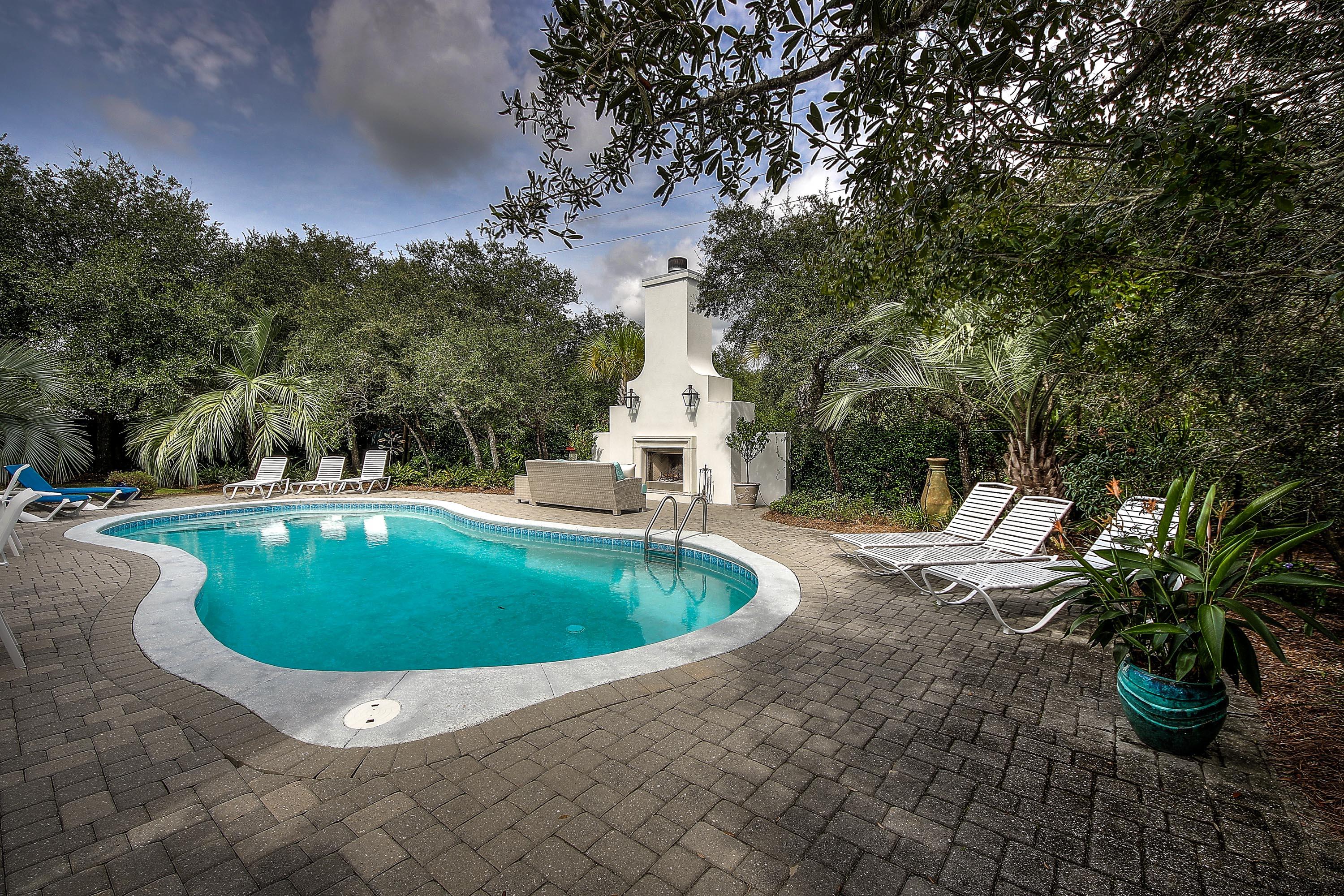 44 Brenda Lane Inlet Beach, FL 32461 - Photo 37 of 39 a view of a swimming pool with a yard and large trees