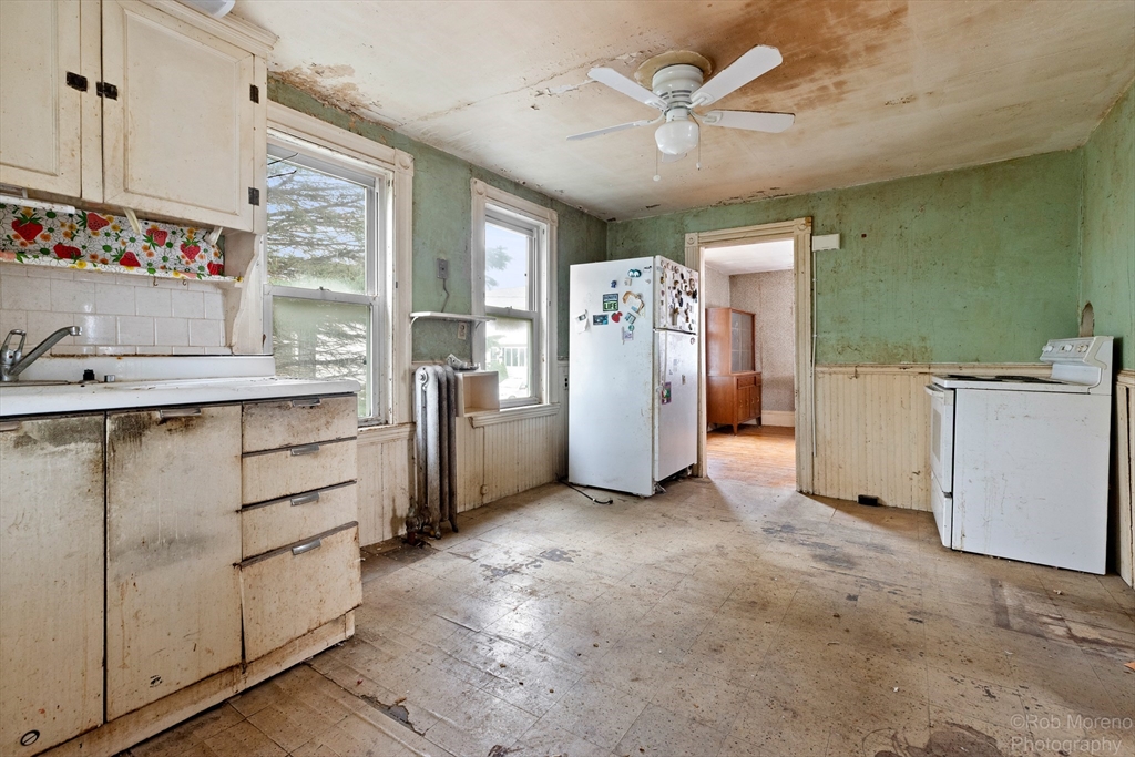 20 Harlow Street Saugus, MA 01906 - Photo 18 of 31 a view of kitchen with refrigerator cabinets and window