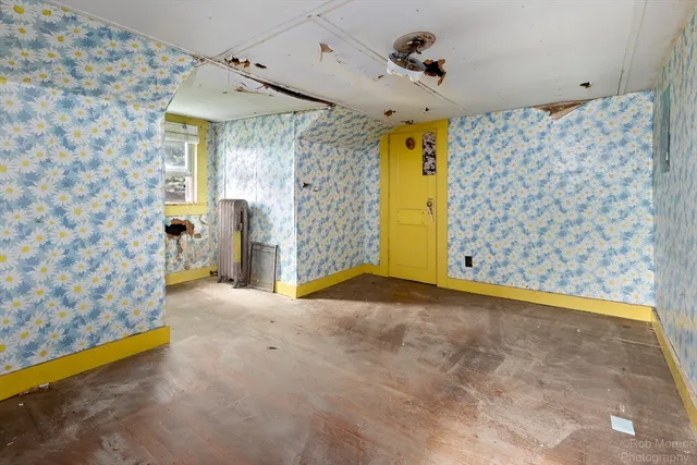 a kitchen with a sink chandelier and living room view