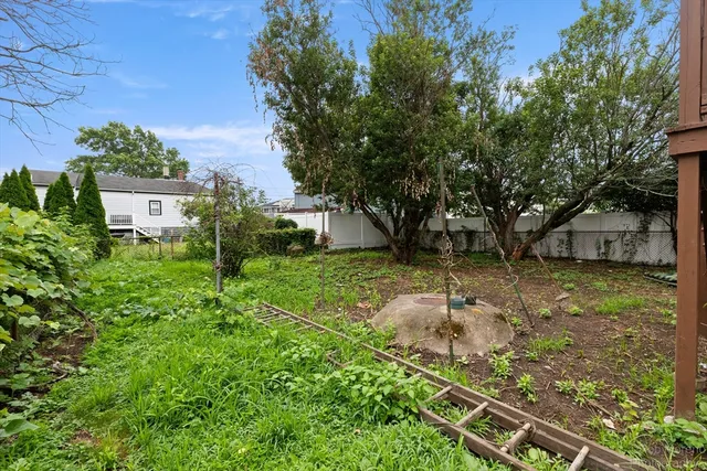 a backyard of a house with table and chairs