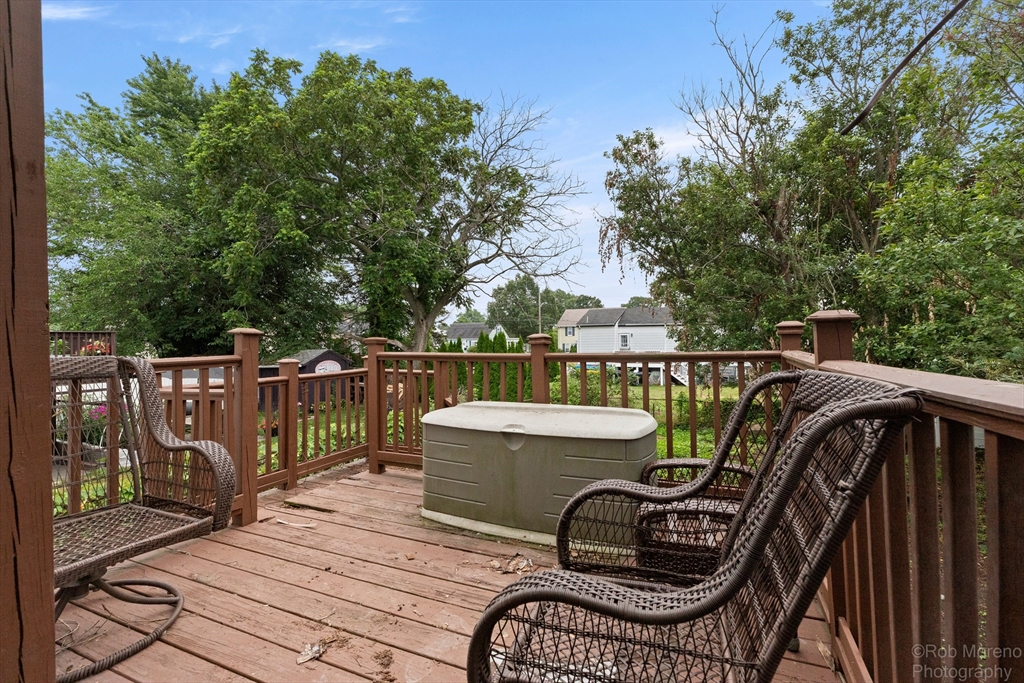 20 Harlow Street Saugus, MA 01906 - Photo 10 of 31 a view of a roof deck with table and chairs a barbeque with wooden fence and floor
