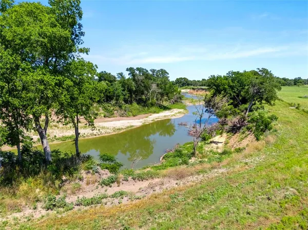 a view of a lake with houses in the background