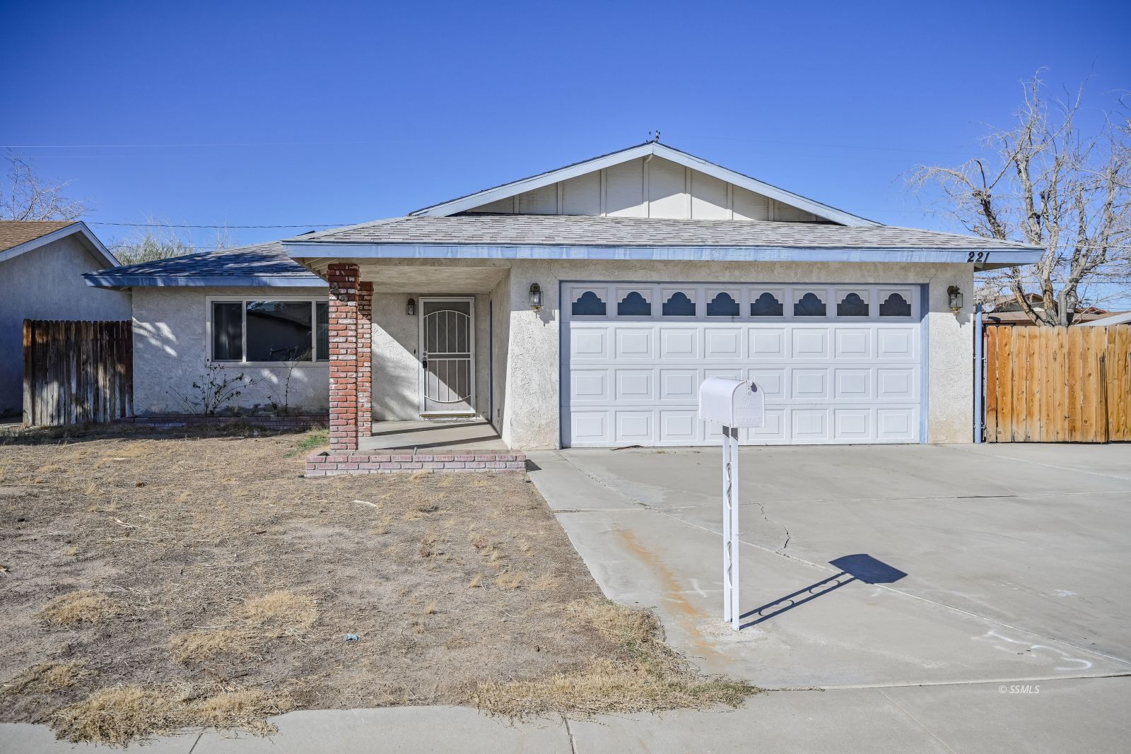 221 South Silver Ridge Street Ridgecrest, CA 93555 - Photo 1 of 44 a front view of a house with a yard and garage