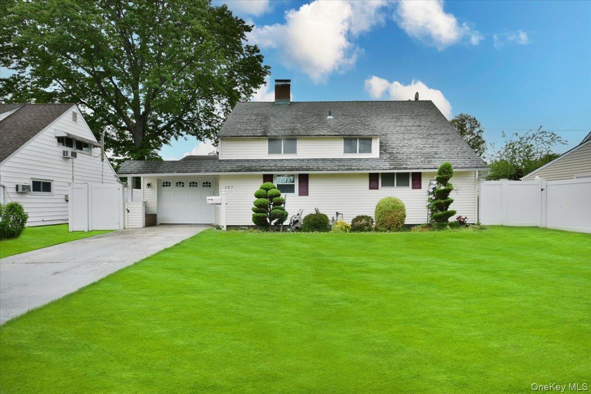 307 Blacksmith Road Levittown, NY 11756 - Photo 1 of 27 a view of a white house with a yard and a large tree