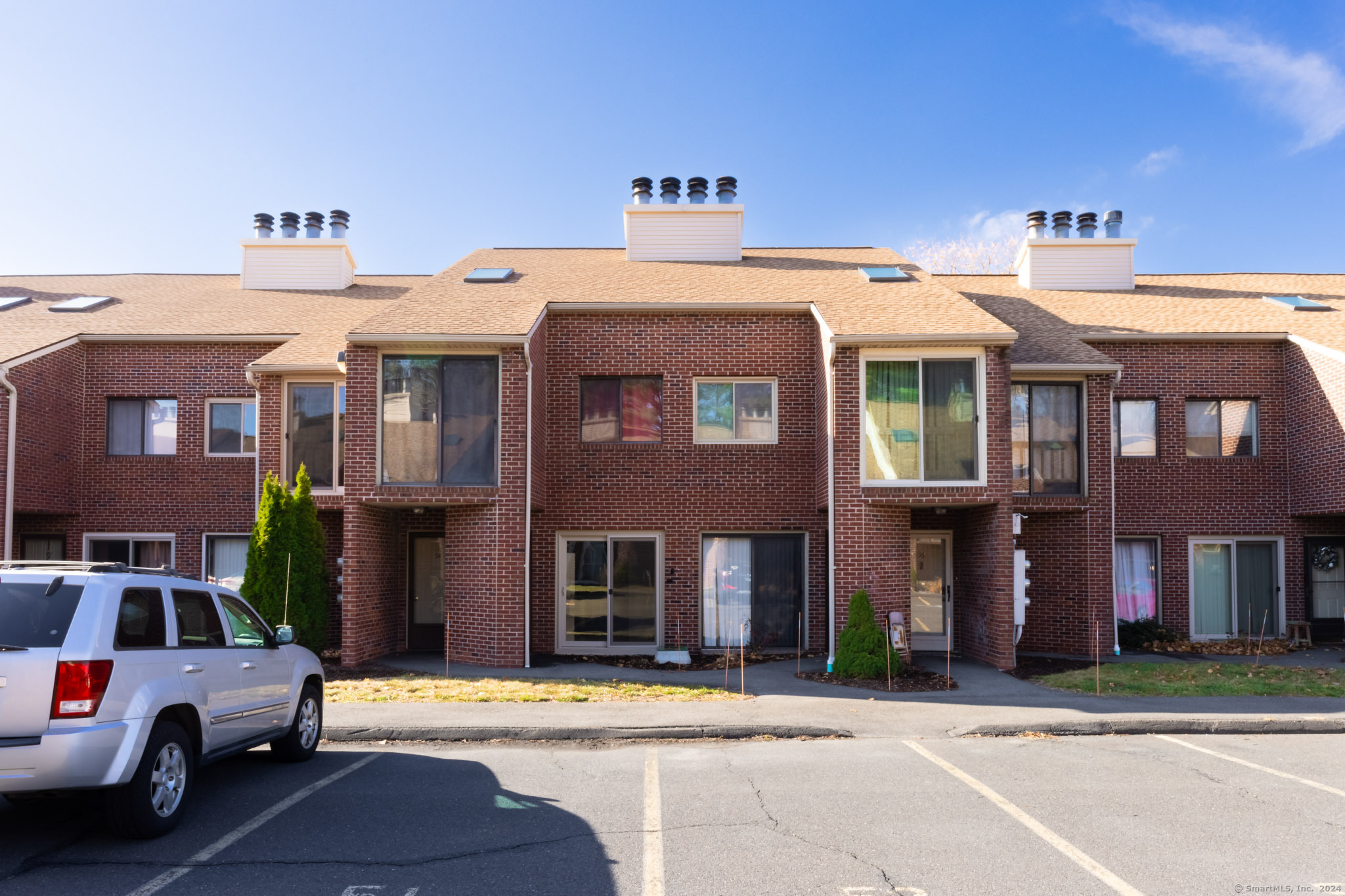 279 Redstone Hill Road, Unit 53 Bristol, CT 06010 - Photo 1 of 1 a front view of a building with street