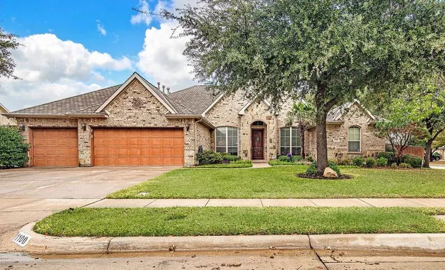 a front view of a house with a yard and garage
