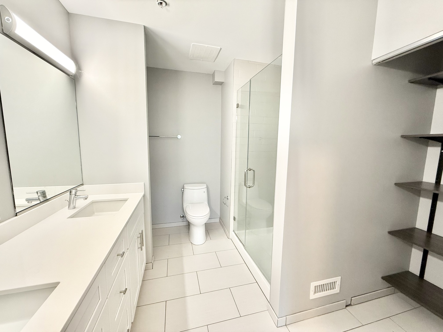 1900 West Lawrence Avenue, Unit 231 Chicago, IL 60640 - Photo 17 of 28 a spacious bathroom with a granite countertop sink a toilet and a shower
