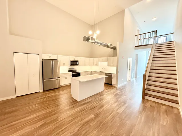 a view of kitchen with microwave and refrigerator