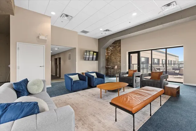 a roof deck with outdoor seating and city view