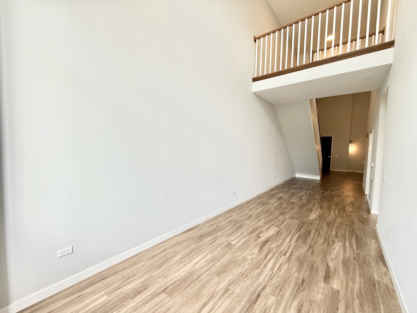 1900 West Lawrence Avenue, Unit 231 Chicago, IL 60640 - Photo 7 of 28 a view of a hallway with wooden floor and a bathroom