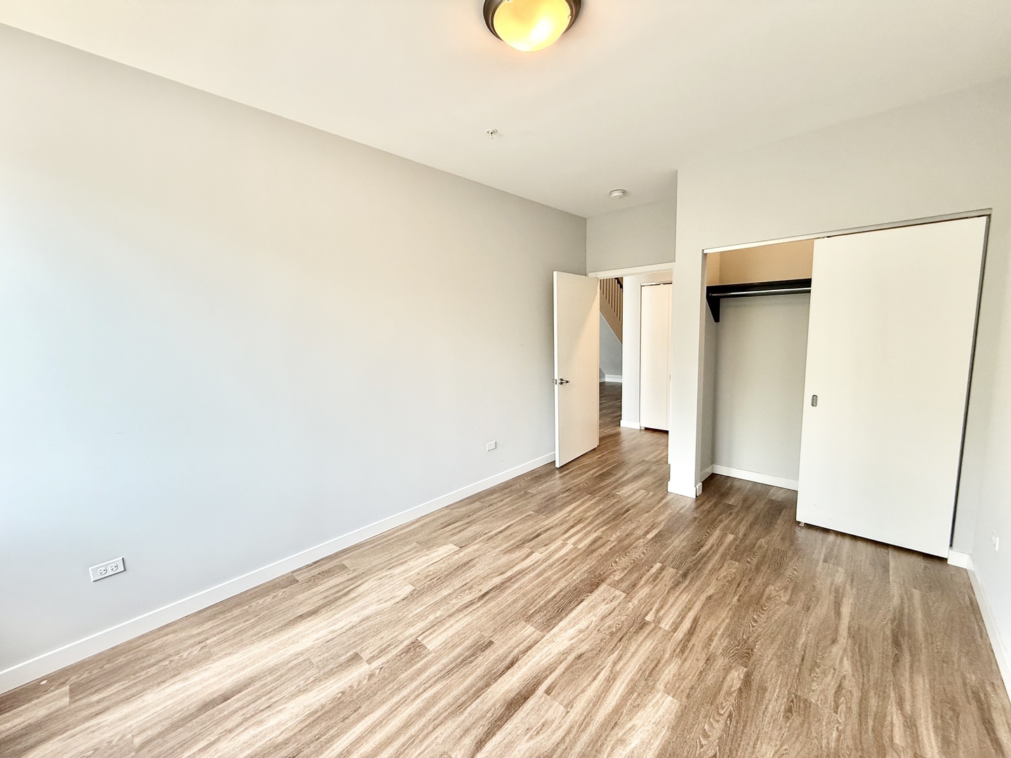 1900 West Lawrence Avenue, Unit 231 Chicago, IL 60640 - Photo 10 of 28 a view of an empty room with wooden floor and a window
