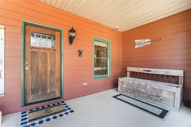 a kitchen with stainless steel appliances kitchen island granite countertop a table chairs stove and refrigerator