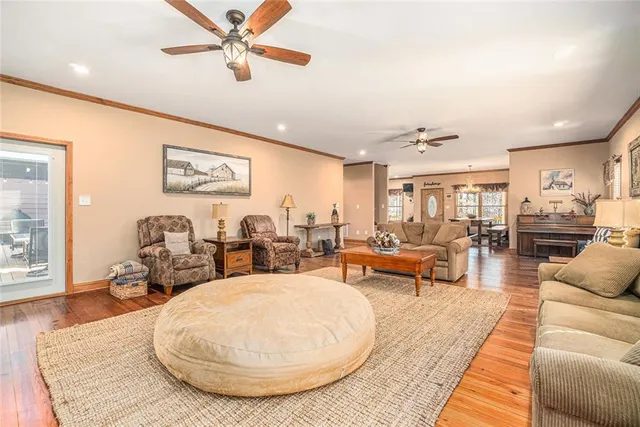 a spacious bedroom with a bed a flat screen tv and couches