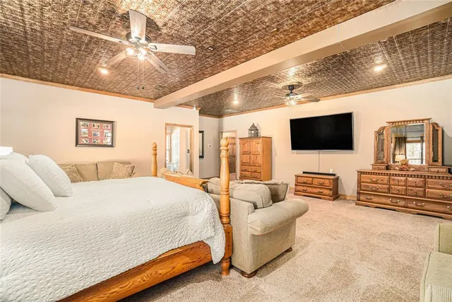 a bedroom with a bed and furniture with outer view