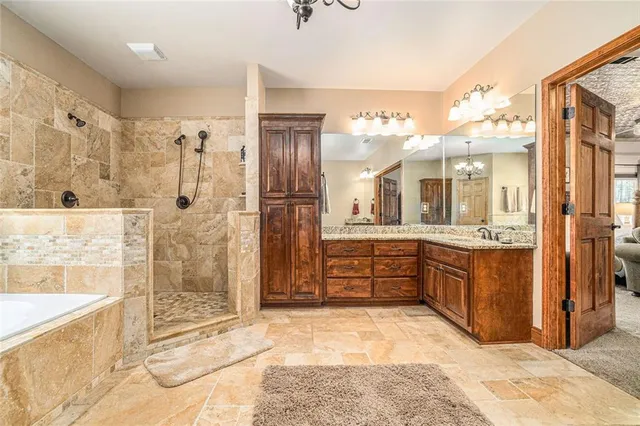 a bathroom with a granite countertop toilet sink and mirror