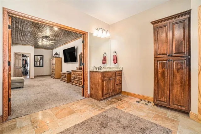 a bedroom with a bed and ceiling fan