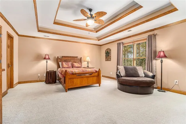 a front view of a house with swimming pool and porch with furniture