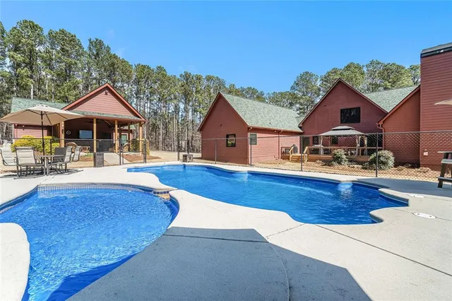 a backyard of a house with barbeque oven table and chairs