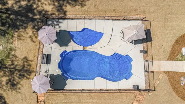 a view of a house with a yard and large tree