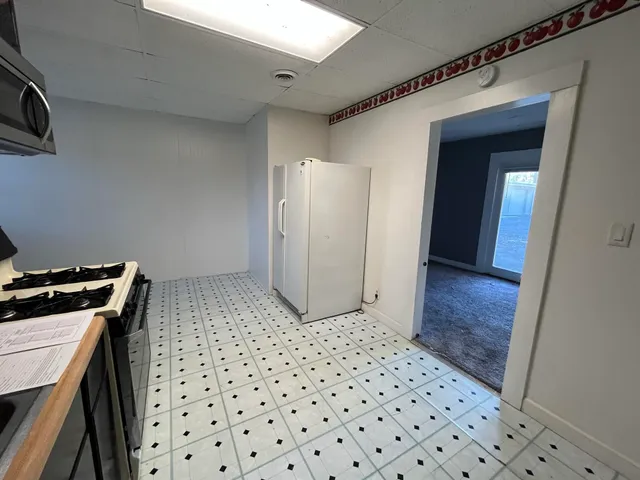 an empty room with a empty space and windows