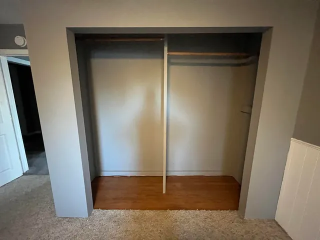 a bathroom with a toilet sink a mirror and vanity