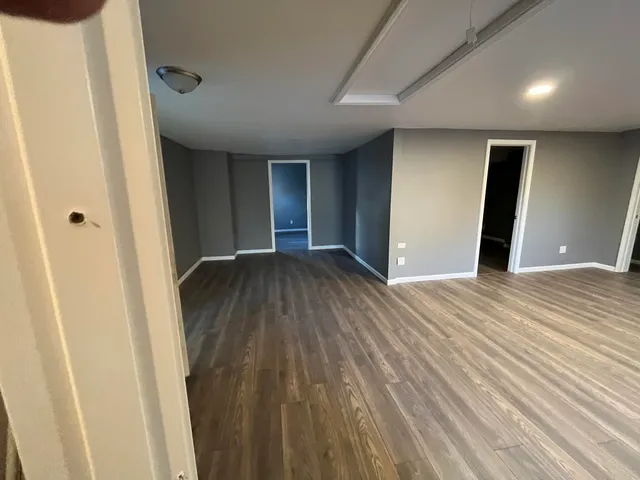 a view of a hallway with wooden floor
