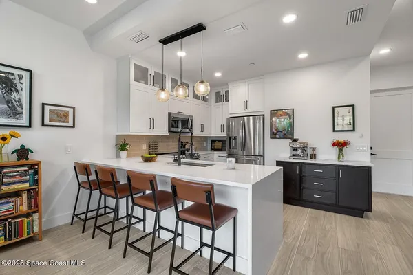 a large kitchen with a table and chairs