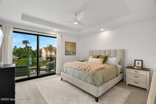 a spacious bedroom with a bed and a window