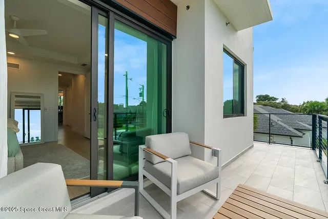 a balcony with furniture and a potted plant