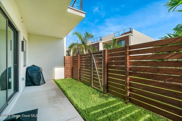 an aerial view of a house with a garden and swimming pool