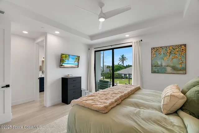 a bedroom with a balcony a bed and a television