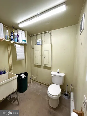 a bathroom with a toilet a sink and mirror
