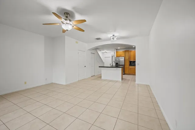 a view of a livingroom with a ceiling fan and wooden floor