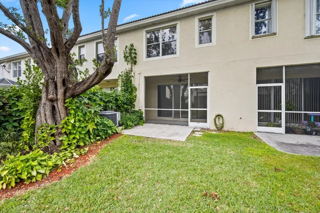 a view of a house with backyard and sitting area