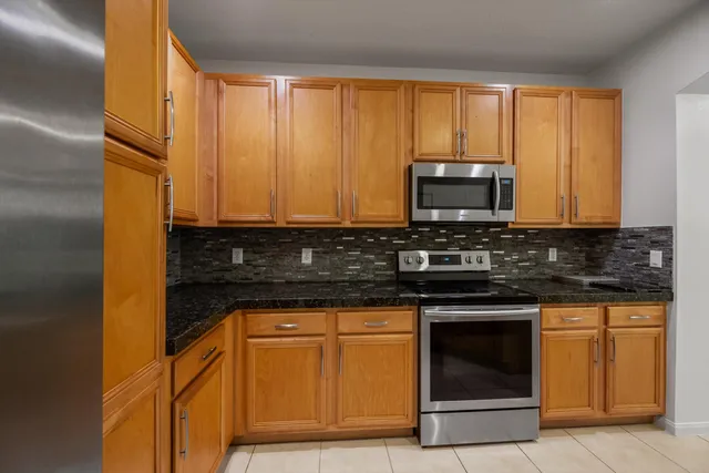 a kitchen with appliances a sink and cabinets