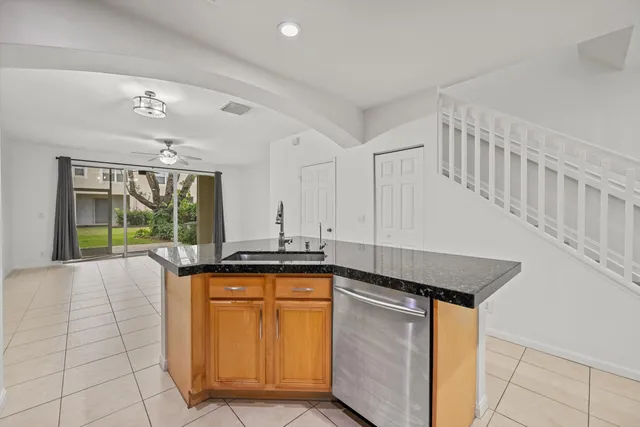 a kitchen with granite countertop a sink and cabinets